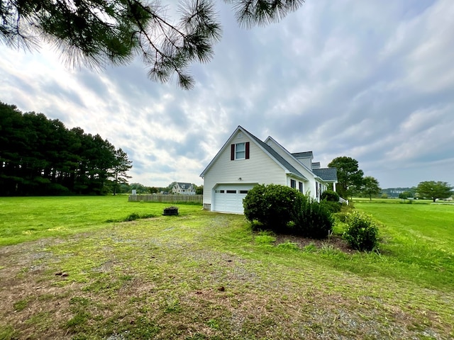 view of property exterior with a yard and a garage