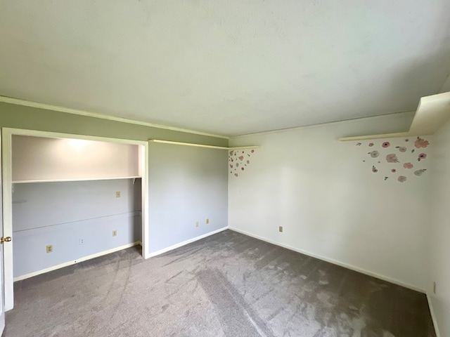 unfurnished bedroom with dark colored carpet