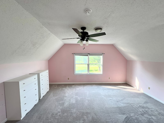 additional living space featuring carpet floors, ceiling fan, and lofted ceiling