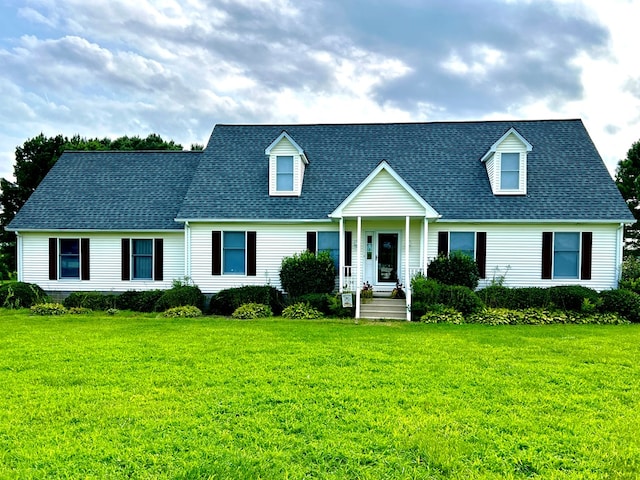 cape cod house with a front lawn