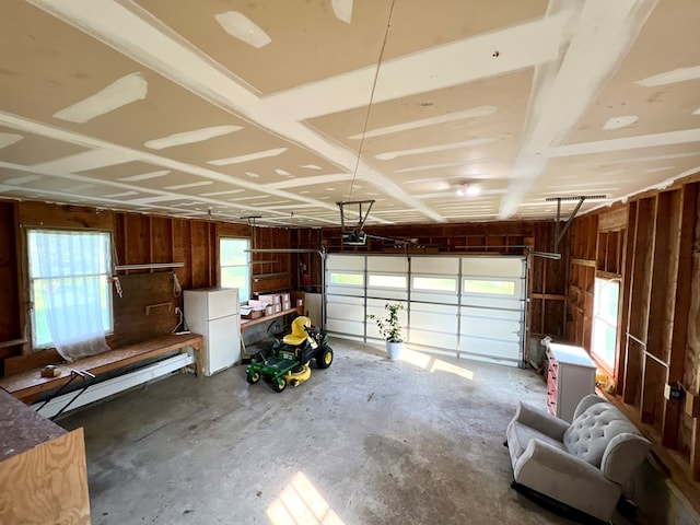 garage with white fridge and a garage door opener