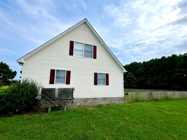 view of property exterior with a lawn