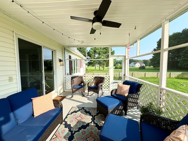 sunroom featuring ceiling fan