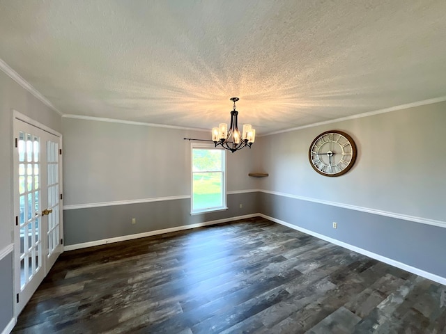 spare room with a textured ceiling, dark hardwood / wood-style flooring, crown molding, and a notable chandelier