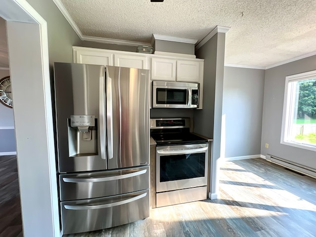 kitchen with a textured ceiling, stainless steel appliances, white cabinetry, and light hardwood / wood-style flooring