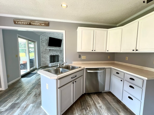 kitchen featuring dishwasher, white cabinets, sink, a textured ceiling, and kitchen peninsula