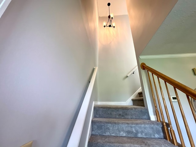 stairway featuring a notable chandelier