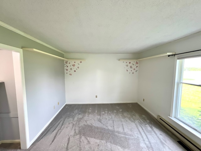 unfurnished room featuring carpet flooring, ornamental molding, a textured ceiling, and a baseboard heating unit