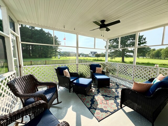 sunroom / solarium featuring ceiling fan