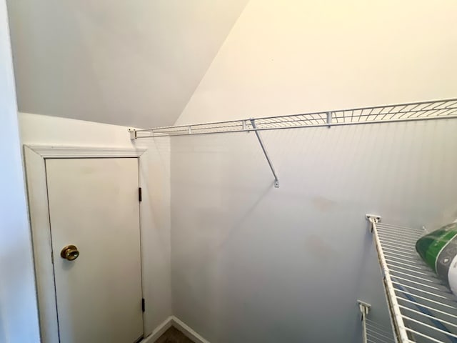 walk in closet with lofted ceiling