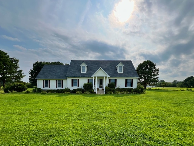 cape cod house featuring a front yard