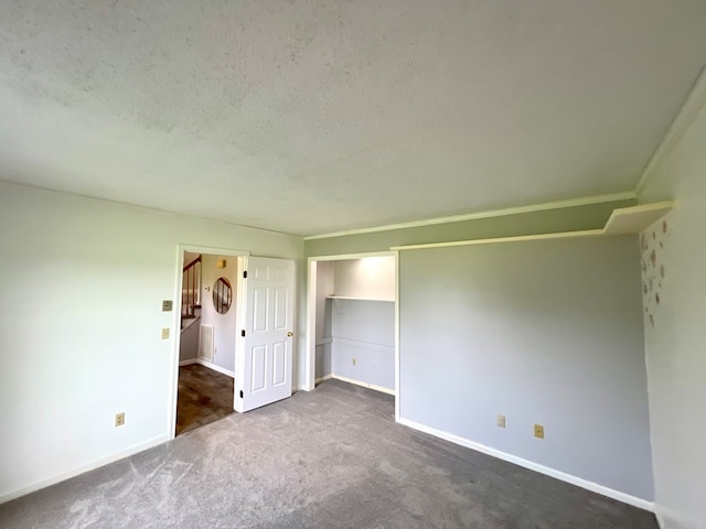 unfurnished bedroom with carpet and a textured ceiling