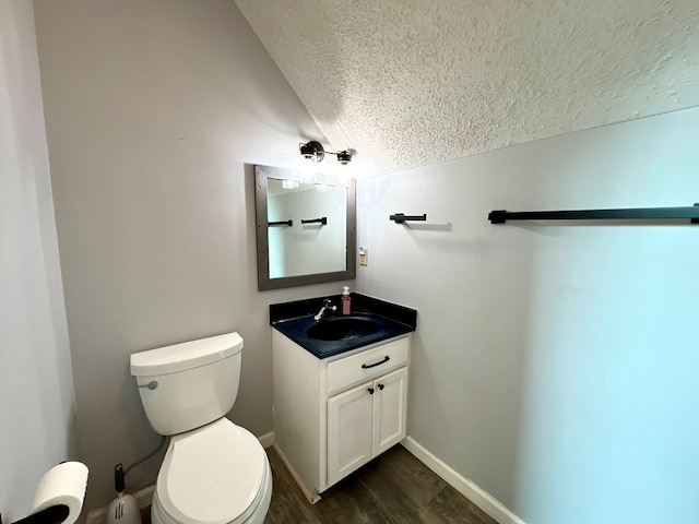 bathroom featuring hardwood / wood-style floors, vanity, a textured ceiling, and toilet