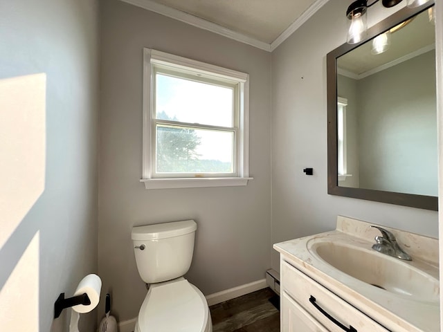 bathroom featuring a baseboard radiator, ornamental molding, toilet, vanity, and hardwood / wood-style flooring