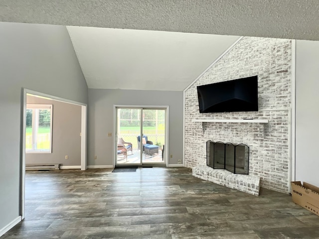 unfurnished living room with a fireplace, lofted ceiling, a baseboard radiator, and a healthy amount of sunlight