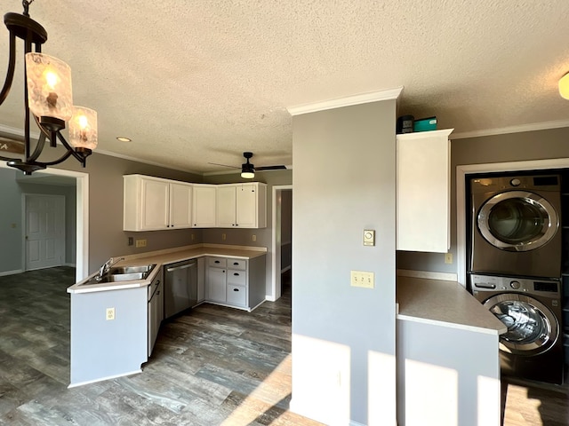 kitchen with white cabinetry, dishwasher, stacked washer / dryer, pendant lighting, and ceiling fan with notable chandelier