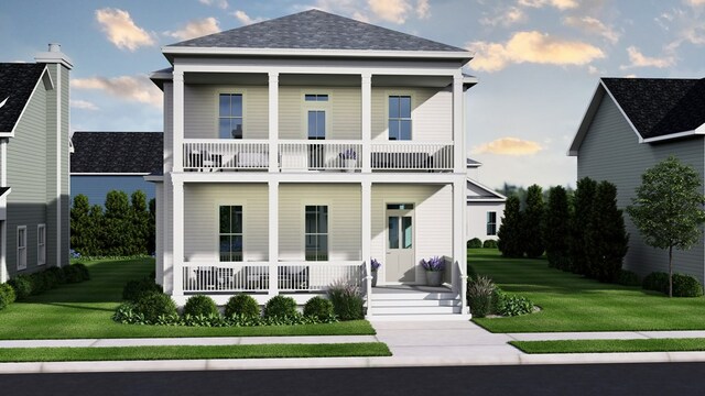 view of front of house with a balcony and a front yard