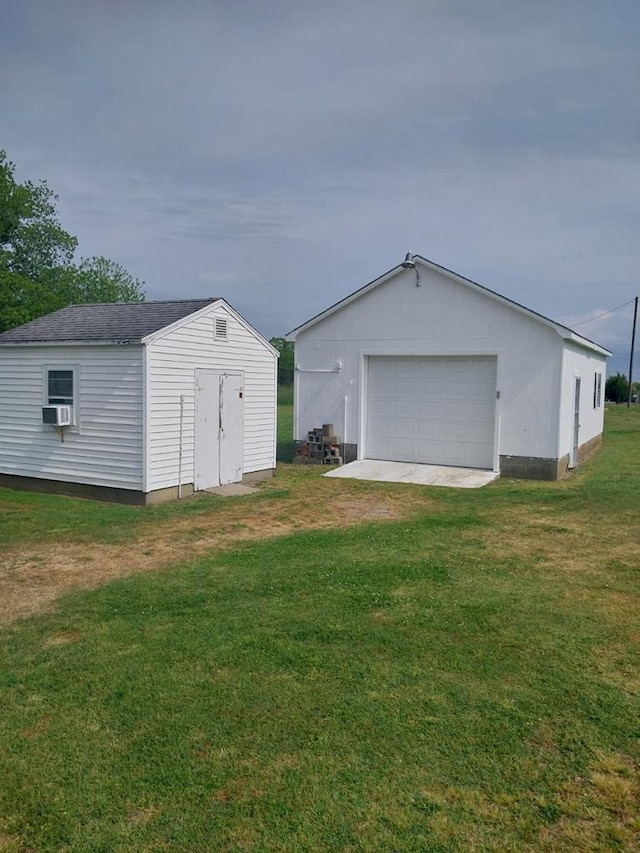 garage with a lawn and cooling unit