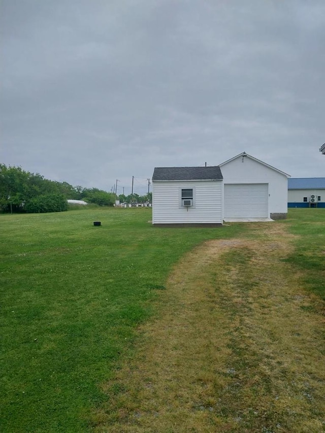 exterior space with a yard and a garage