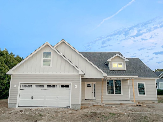 view of front facade featuring a porch and a garage