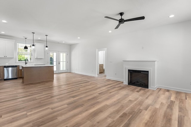 22199 Verlinda Lndg S, Cape Charles, VA 23310 - unfurnished living room with recessed lighting, a ceiling fan, a fireplace, and light wood finished floors