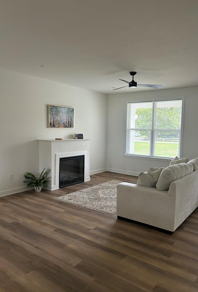 22199 Verlinda Lndg S, Cape Charles, VA 23310 - living area featuring a glass covered fireplace, dark wood finished floors, and ceiling fan
