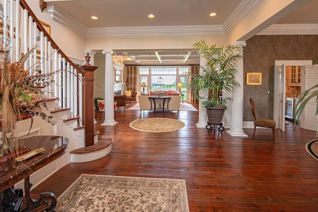 foyer with beam ceiling, ornate columns, dark wood-type flooring, and coffered ceiling