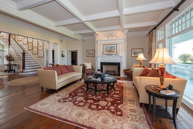 living room with beam ceiling, coffered ceiling, crown molding, a fireplace, and hardwood / wood-style flooring