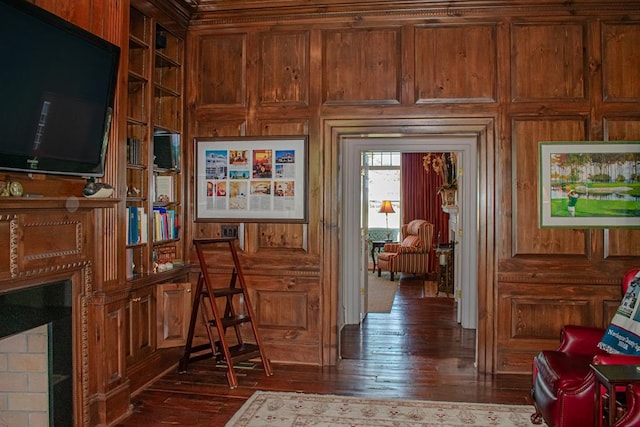 interior space with built in shelves and hardwood / wood-style floors