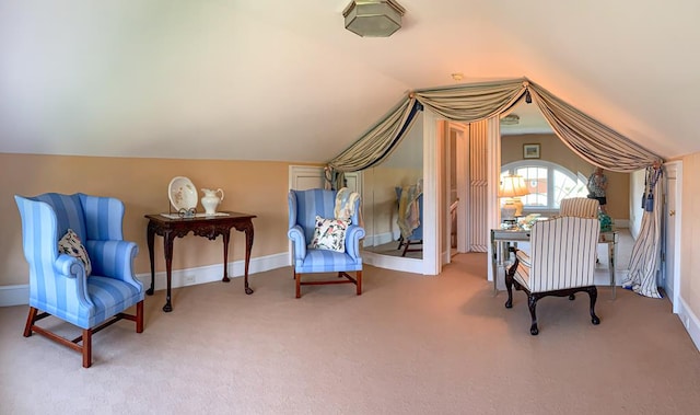 sitting room featuring lofted ceiling and carpet floors