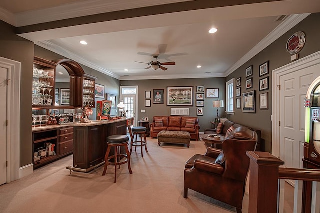 bar featuring ceiling fan, ornamental molding, and light carpet