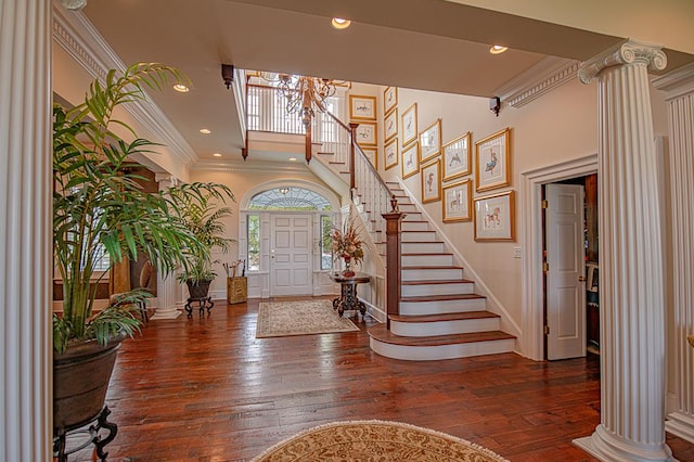 entryway featuring ornate columns and dark hardwood / wood-style flooring