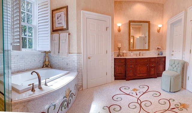 bathroom featuring tile patterned flooring, vanity, and a relaxing tiled tub