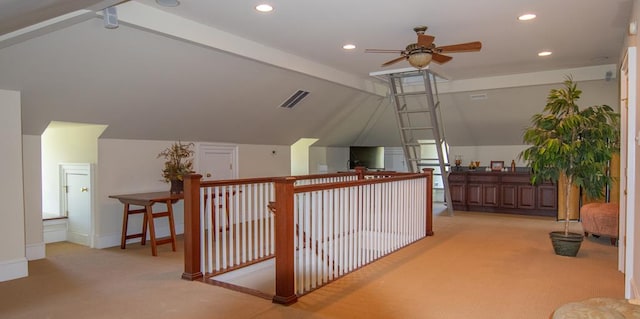 hall featuring vaulted ceiling with beams and light colored carpet