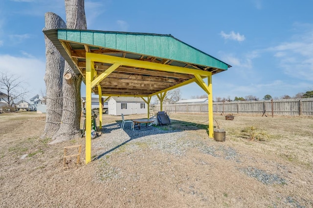 exterior space featuring an outbuilding and fence