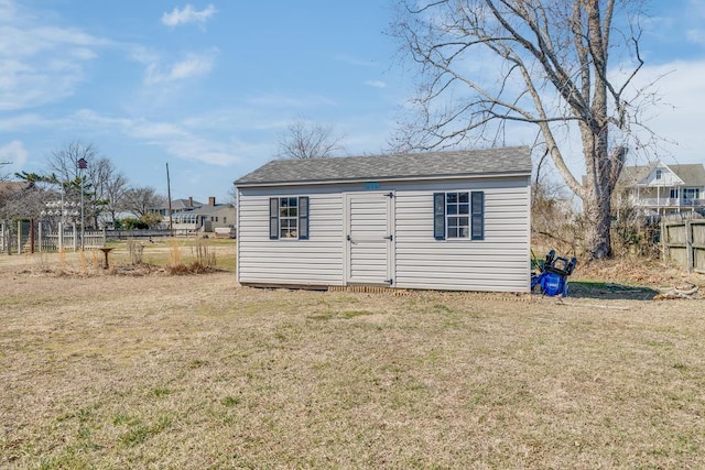 view of shed featuring fence