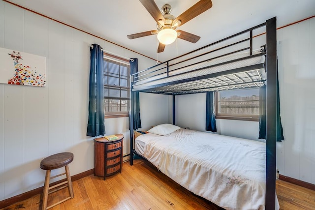 bedroom featuring baseboards, ceiling fan, and hardwood / wood-style floors