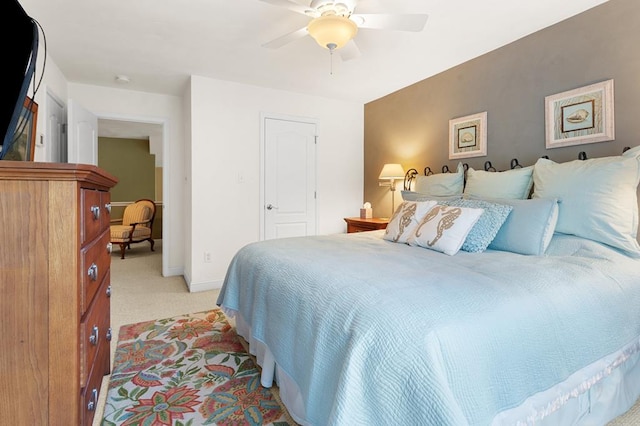 carpeted bedroom featuring a closet and ceiling fan