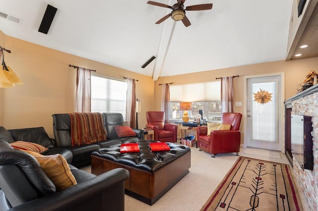 living room with light carpet, vaulted ceiling with beams, a fireplace, and ceiling fan