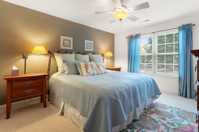 bedroom featuring light colored carpet and ceiling fan