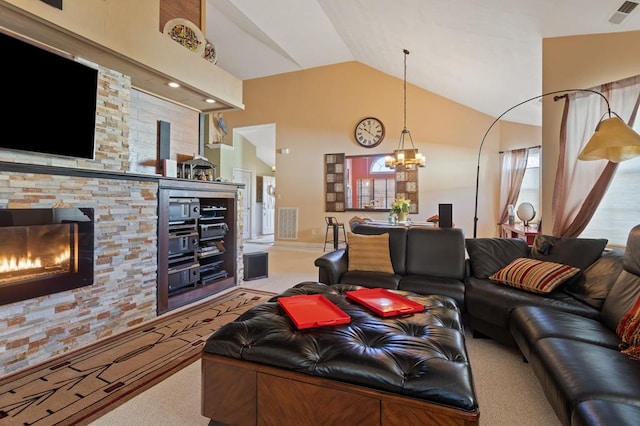 carpeted living room featuring lofted ceiling, a healthy amount of sunlight, an inviting chandelier, and a fireplace