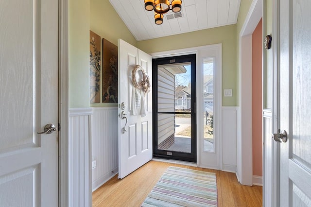 foyer entrance featuring vaulted ceiling and light hardwood / wood-style floors