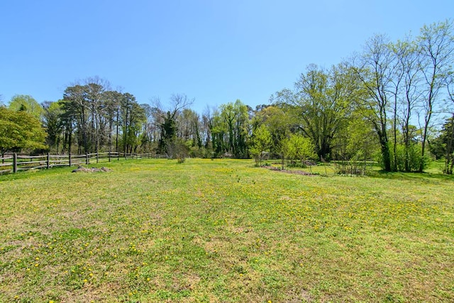 view of yard featuring a rural view and fence