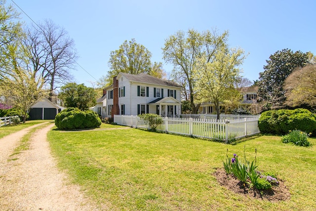 exterior space featuring dirt driveway, a front lawn, and fence private yard