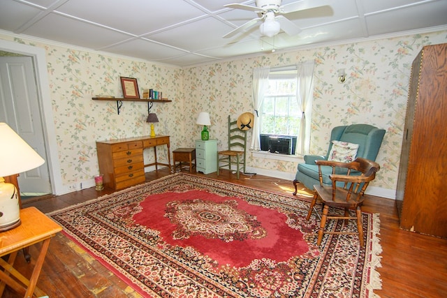 sitting room with baseboards, a ceiling fan, crown molding, and wood finished floors