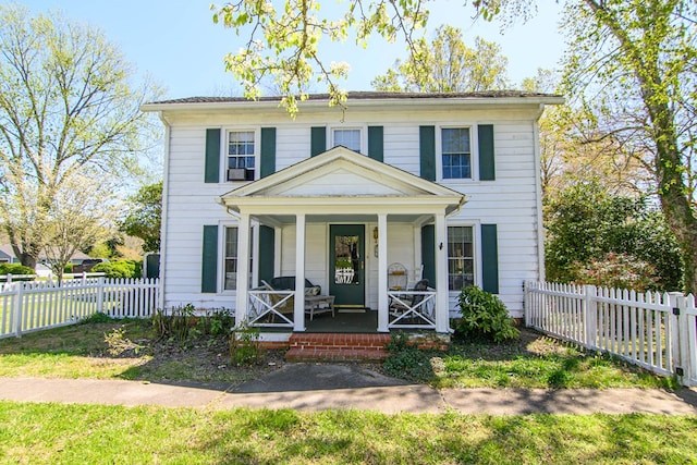 view of front of property with a porch and fence