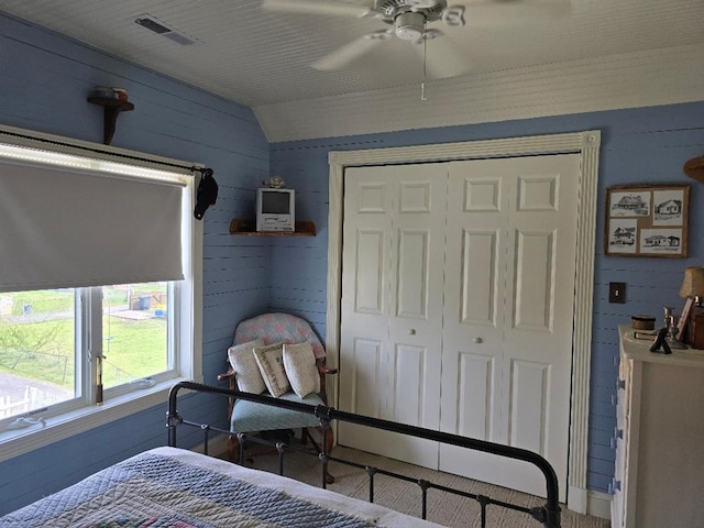 bedroom with visible vents, ceiling fan, lofted ceiling, and a closet