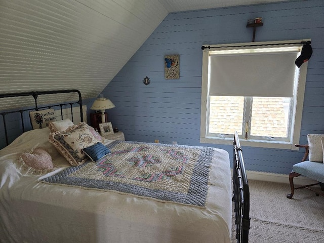 carpeted bedroom with baseboards and lofted ceiling