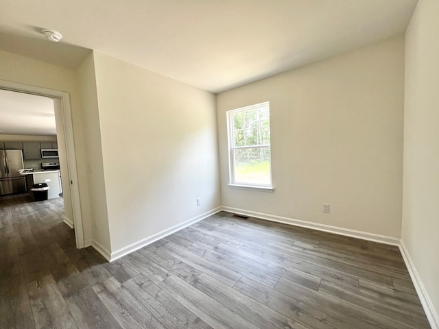 spare room with wood-type flooring