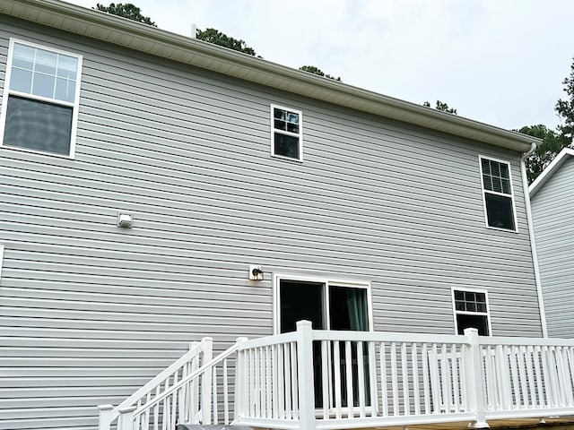 view of side of property featuring a wooden deck